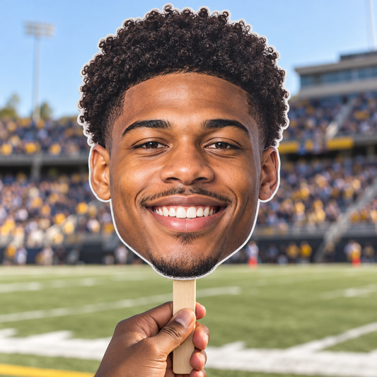 Sample mockup of a face-only big head photo cutout with a wooden handle at a football stadium.
